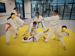 A group of karate students pose in a fun diorama of an all-against-all fight